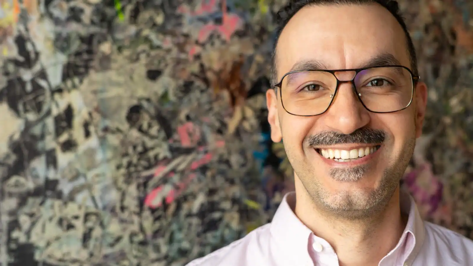 Porträt von Dr. Tanyo Hristov vor abstraktem Hintergrund